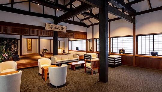 A guest lounge at Shirakabe, with original timber beams and low seating